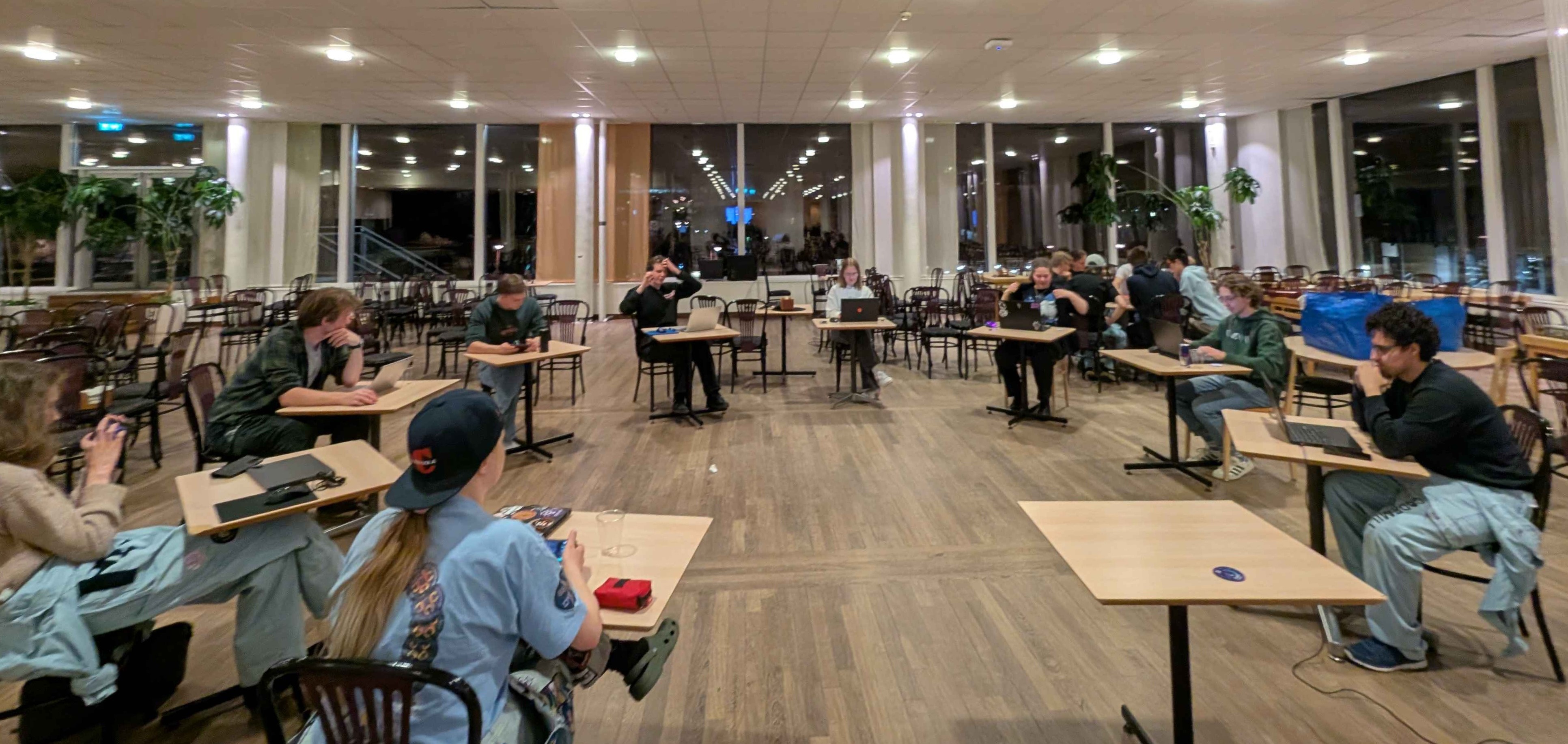 Circle of people at desks with laptops
