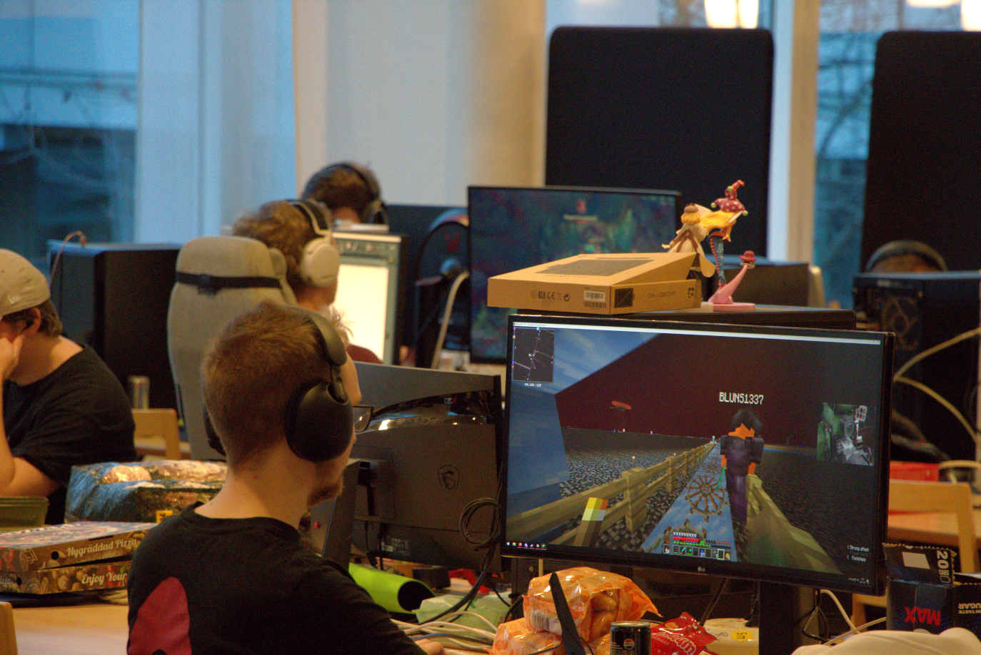 Multiple rows of gamers with headsets